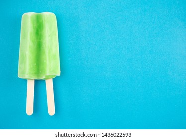 Green Popsicle on a Blue Background