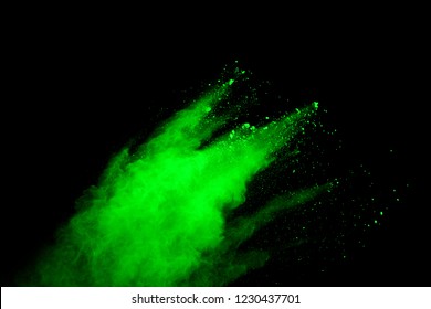 Green Powder Explosion On Black Background. Colored Cloud. Color Dust Explode. Paint Holi.