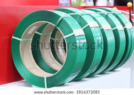 Green PP band for packaging and fastening of carton box ; Business industrial background 