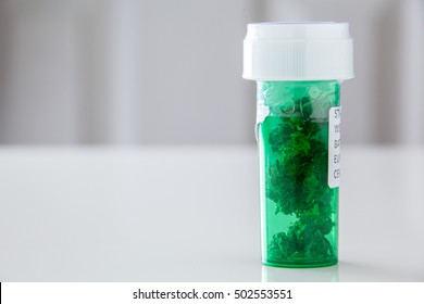 Green Prescription Bottle Of Medical Marijuana From Dispensary Referred By Doctor.