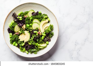 Green And Purple Kale Salad With Beans, Avocado And Cucumber. Healthy Vegan Food Concept.