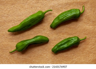 Green Raw Chili Peppers Top View On Paper Table. Anaheim Heirloom Variety Of Home-grown Chili Vegetable.