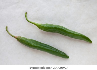 Green Raw Chili Peppers Top View On Gray Table. Home-grown Pepper Vegetables Numex Heritage Big Jim Variety.