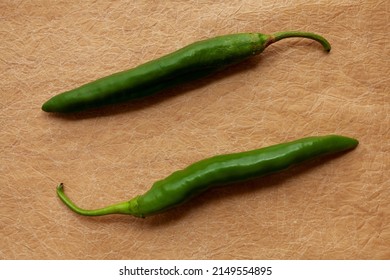 Green Raw Chili Peppers Top View On Brown Paper. Home-grown Pepper Vegetables Numex Heritage Big Jim Variety.