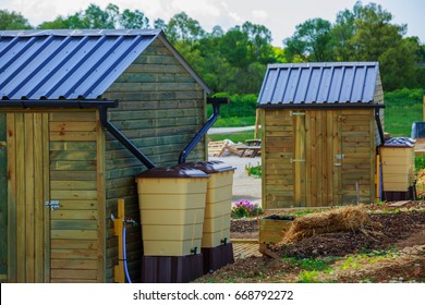 Green Recovery Of Rainwater Outside In Town Garden With Small Wooden Cabin