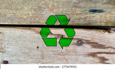 Green Recycling Icon On Abandoned Wooden Boards From Construction Site, Recycle And Reuse Waste Building Materials To Reduce Industrial Pollution And Protect Our Nature, Environment Friendly Symbol