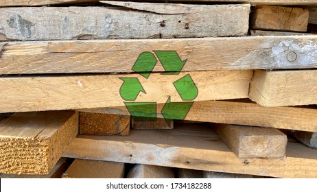 Green Recycling Icon On Waste Wood Planks From Construction Site, Sort And Reuse Abandoned Materials, Sustainable Responsible Development Concept, Creative Environmental Protection Symbol Background