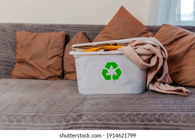 Green Recycling Sign On White Plastic Container At Home. Throwing Out Old Clothes. Recycle Old Clothes.