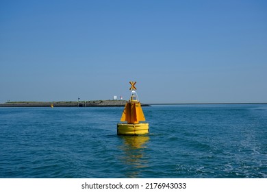 Green red buoy to mark a split in the canal Nieuwe Waterweg in the harbor of Rotterdam, the Netherlands.