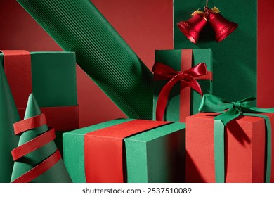 Green and red gift boxes of all sizes, placed side by side create a product display space on their empty surfaces, decorated with delicate Christmas decorations that make the space look bright red. - Powered by Shutterstock