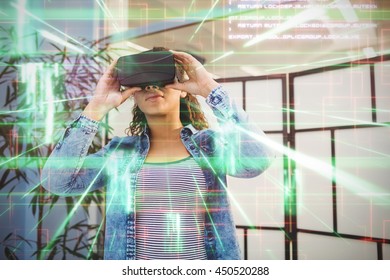 Green and red lines next to screens against low angle view of executive enjoying virtual reality headset at creative office - Powered by Shutterstock