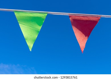 Green And Red Pennant Against A Blue Frosty Sky.