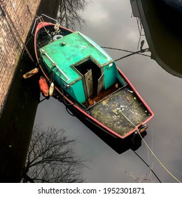 A Green And Red Row Boat In An Amsterdam Canal