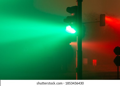 green and red traffic lights in a foggy night
