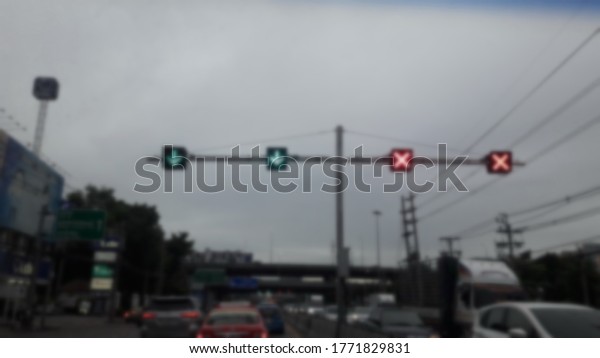 Green, red traffic lights show open-close lines\
along the car path\
blurred.