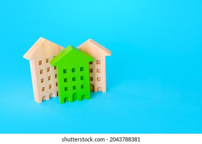 Green Residential Building Among Houses. Environmentally Friendly, Energy Efficient. New Sustainable Building Codes And Standards. Search For Best Option To Buy. Net Zero Carbon Neutrality.