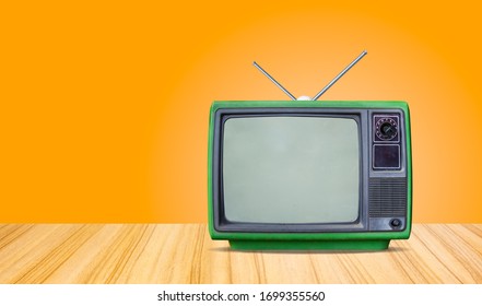 Green Retro Old Television Receiver On Table Front Gradient Orange  Wall Background,perspective Wooden Floor Texture And,vintage Tv