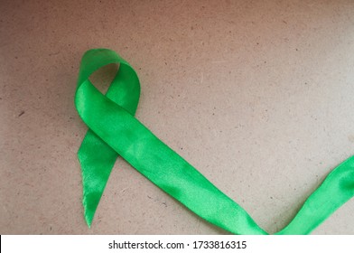 green ribbon awareness, mental health and lymphoma, World Mental Health Day. The problem of cerebral palsy, organ transplantation. Organ donations. Kidney cancer - Shutterstock ID 1733816315