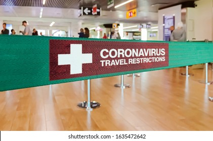 Green ribbon barrier inside an airport with the warning of travel restrictions due to the spread of the dangerous Coronavirus - Shutterstock ID 1635472642