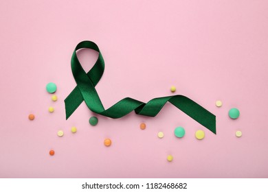 Green ribbon with colorful pills. Medical concept - Shutterstock ID 1182468682