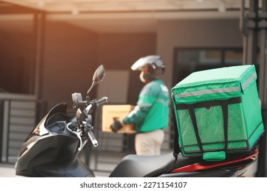 green rider parcel delivery man  of a package through a service send to home. hand holding consigns and submission customer accepting a of box.