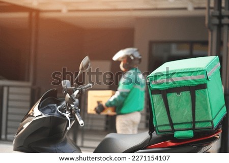 green rider parcel delivery man  of a package through a service send to home. hand holding consigns and submission customer accepting a of box.