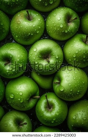 a lot of green ripe apples close-up with water drops