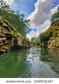 Green river with unique stone cliffs on the edge