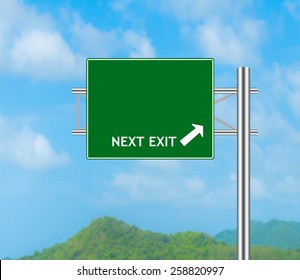 Green Road Sign Concept Next Exit And Sky Background.