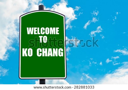 Green road sign with greeting message WELCOME TO KO CHANG, THAILAND isolated over clear blue sky background with available copy space. Travel destination concept  image