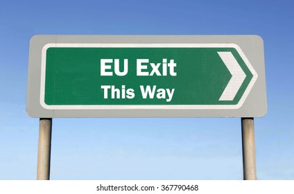 Green Road Sign With The Message Of An EU Exit This Way Concept Against A Blue Sky Background 