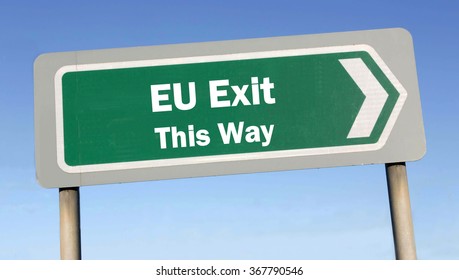 Green Road Sign With The Message Of An EU Exit This Way Concept Against A Blue Sky Background 