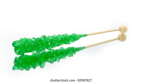 Green Rock Candy With Stick On A White Background With Reflection