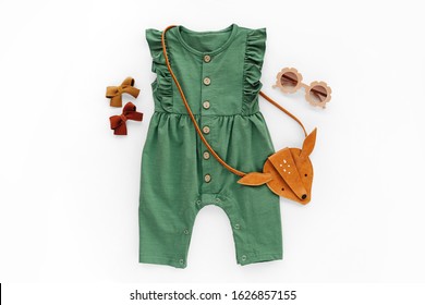 Green Romper With  Kids Handbag And Sunglasses. Set Of  Baby Clothes And Accessories For Spring Or Summer. Fashion Childs Outfit. Flat Lay, Top View