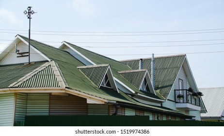 Green Roof Coating. Stock Footage. Beautiful Green Roof Is Made Of Profiled Flooring. New Roof Covering Of Country House. Multi-pitched Roof With Windows On Sides