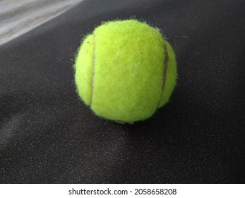 The green rubber ball is used to play tennis