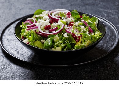 Green Salad with Apples, Goat Cheese, Cranberries, Red Onion and Pepitas in black bowl on concrete table - Powered by Shutterstock