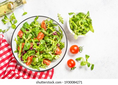 Green Salad With Arugula, Lamb And Tomatoes. Healthy Vegan Dish. Top View At White Table.