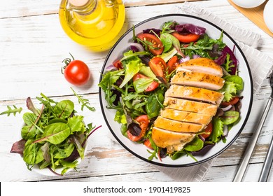 Green Salad With Baked Chicken Breast At White Kitchen Table. Healthy Food, Clean Eating Concept. Top View Image.