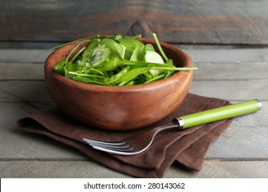 Green salad in bowl on wooden background - Powered by Shutterstock