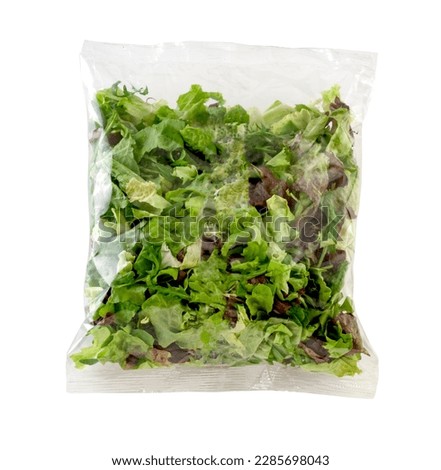 Green salad in cellophane bag. Clipping path.