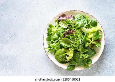 Green salad, Fresh salad leaves and vegetables in white plate. - Powered by Shutterstock