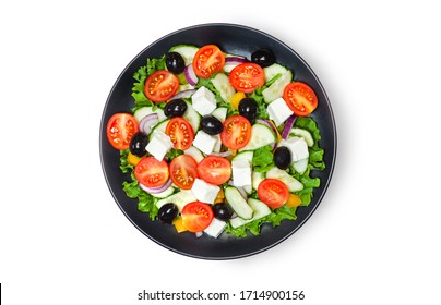 Green Salad With Tomato And Fresh Vegetables In White Bowl On Pink Background. Top View