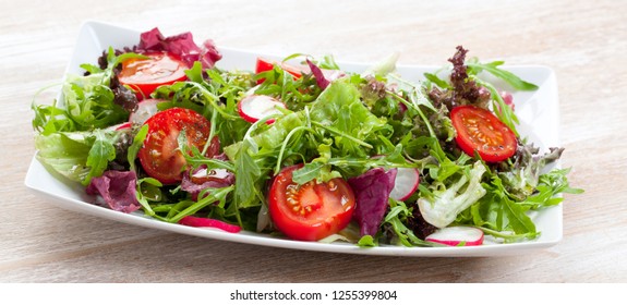 Green Salat In A Bowl On Desk. Tomato, Cheese And Salad