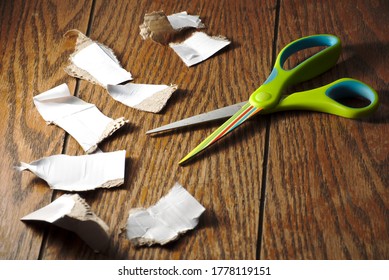 Green Scissors Cutting Paper In A Wood Table, Cutout Concept