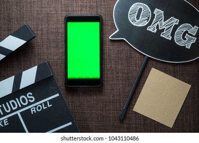 Green Screen Chroma Key Health Application On The Screen Of Mobile Phone With Flatlay Of Movie Or Movie Director Conceptual