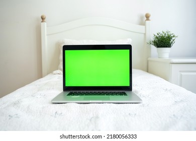 Green Screen Chroma Key Laptop Are On The Bed In Child White Room. Children Use Gadget For E-learning, Chating And Watching Entertainment Content.