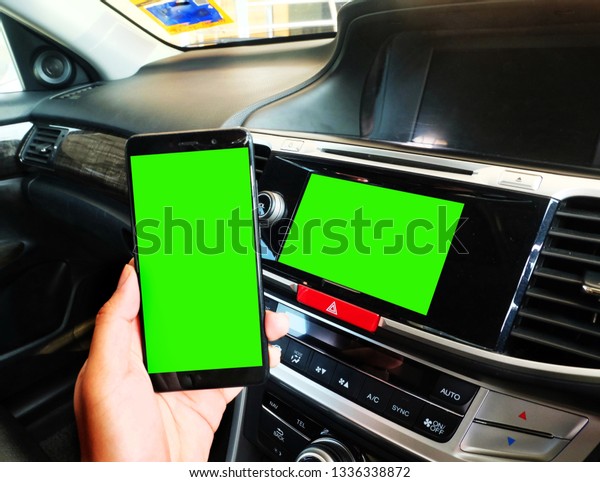 Green screen or chroma key at\
smartphone and car panel screen for smart vehicles\
concept.