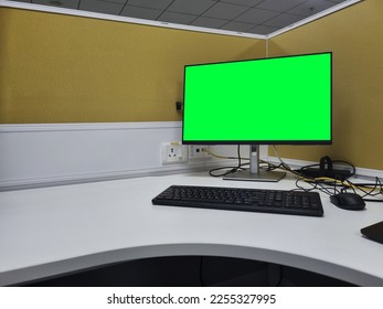 green screen desktop monitor on workstation with copy space in cubicle - Shutterstock ID 2255327995