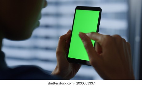 Green Screen Mobile Phone In Business Woman Hands. Closeup Of Smartphone Chroma Key. Close Up Businesswoman Hands Using Phone With Greenscreen. Mobile Technology And Communication Concept